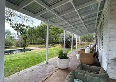 Verandah with timber posts and potted plants