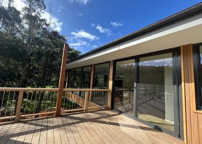 Hardwood deck wrapping around a timber-clad home