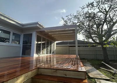 Hardwood deck with built-in timber steps down to the lawn