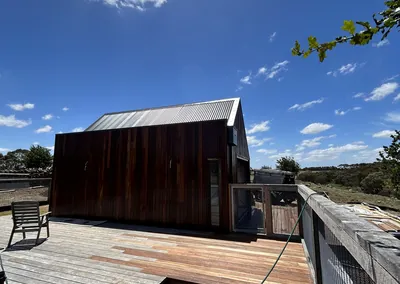 Timber-clad cabin on a large hardwood deck